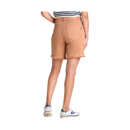 Camel cutoff denim shorts with frayed hems and back patch pockets, shown on a model from the back