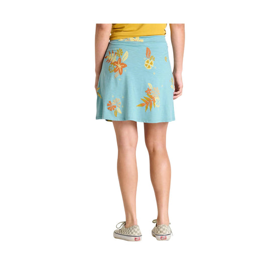 Light blue floral skirt shown from the back, paired with a yellow top and checkered slip-on shoes
