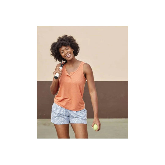 Coral sleeveless henley tank on a model, paired with blue patterned shorts