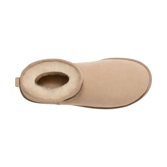 Beige shearling-lined ankle boot with a suede upper and pull tab