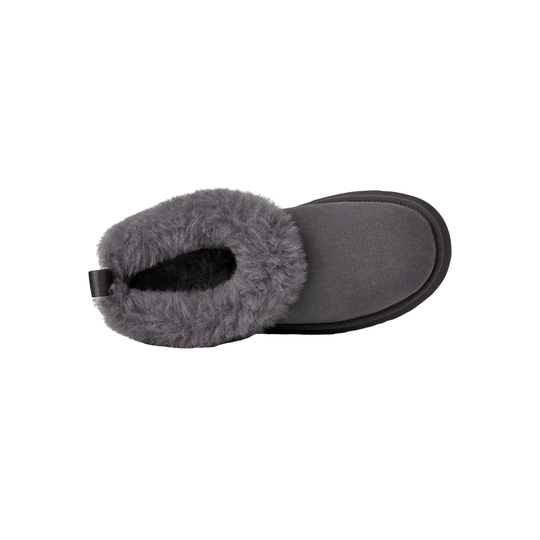 Gray fuzzy slip-on slipper with a rounded toe and black sole, top view on white background