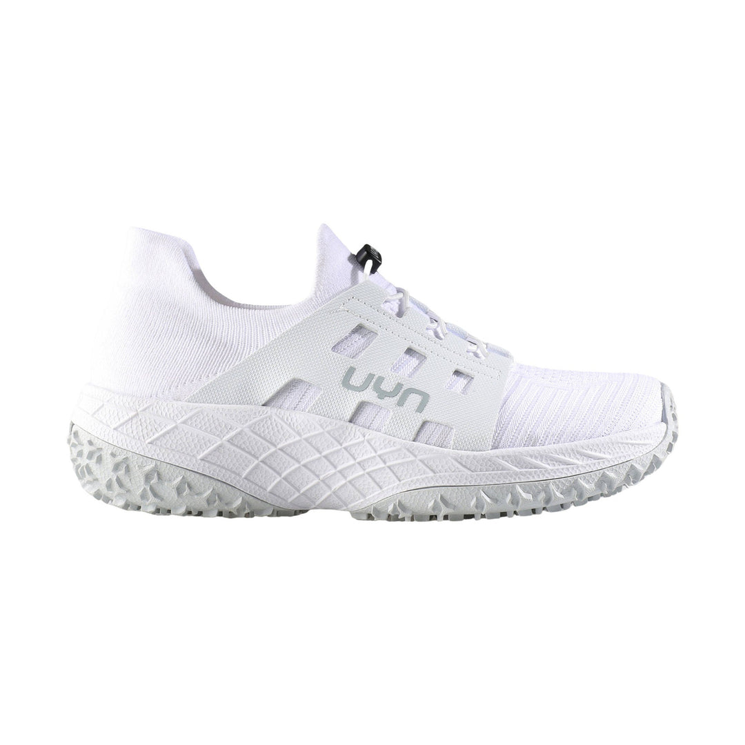 White low-top athletic shoe with knit upper, side cutouts, and rugged treaded sole