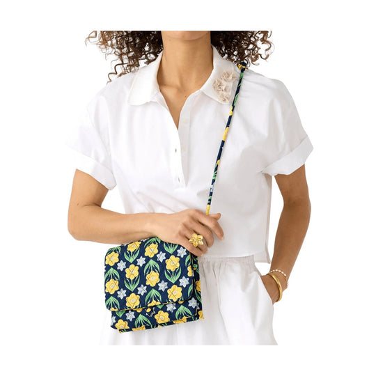 White short-sleeve collared blouse with a floral crossbody hipster bag