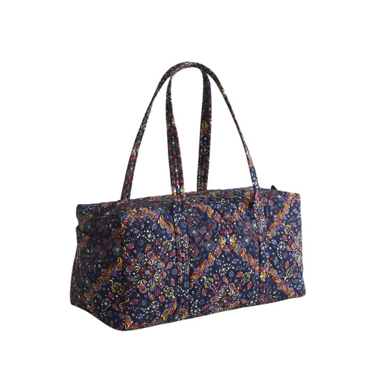 Quilted navy duffel bag with colorful paisley pattern and long shoulder straps