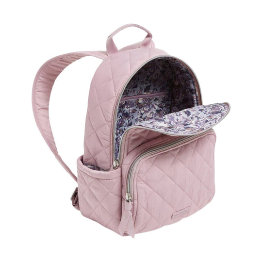 Light pink quilted small backpack with front zip pocket, side bottle pocket, and floral-patterned interior