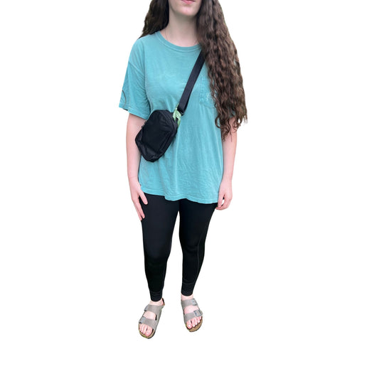 Black small sling backpack with a single shoulder strap