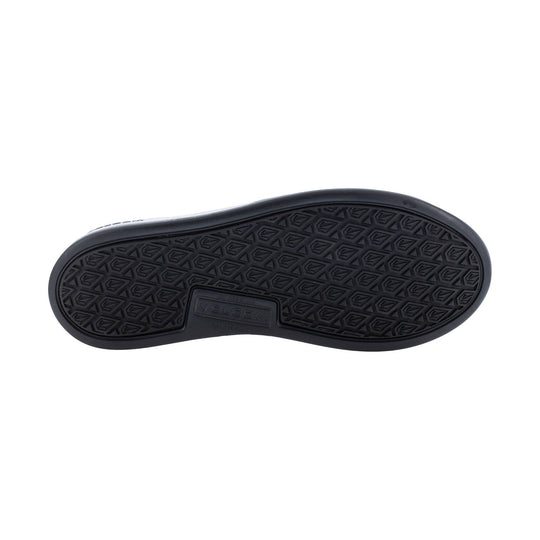 Black shoe outsole with diamond tread pattern and Volcom branding