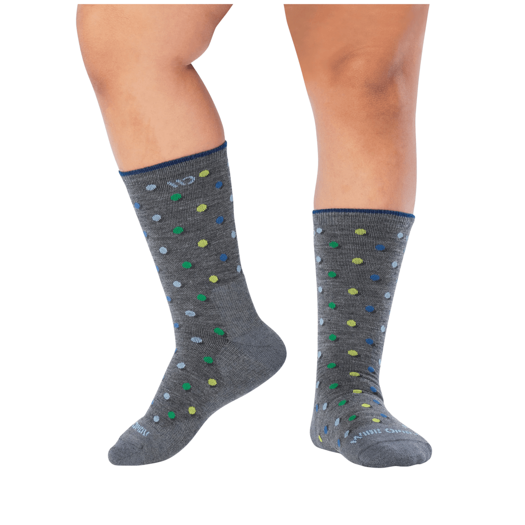 Gray crew socks with multicolored polka dots and blue trim, shown on legs