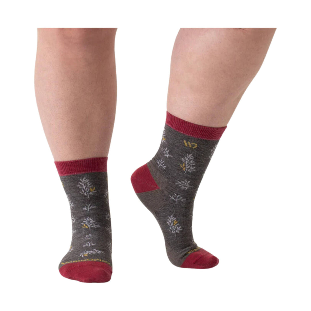 Dark gray ankle socks with red cuffs, heels, and toes, shown on a model’s lower legs.