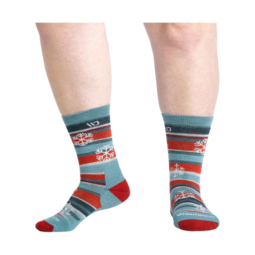 Pair of patterned crew socks in light blue, red, and dark gray with snowflake motifs