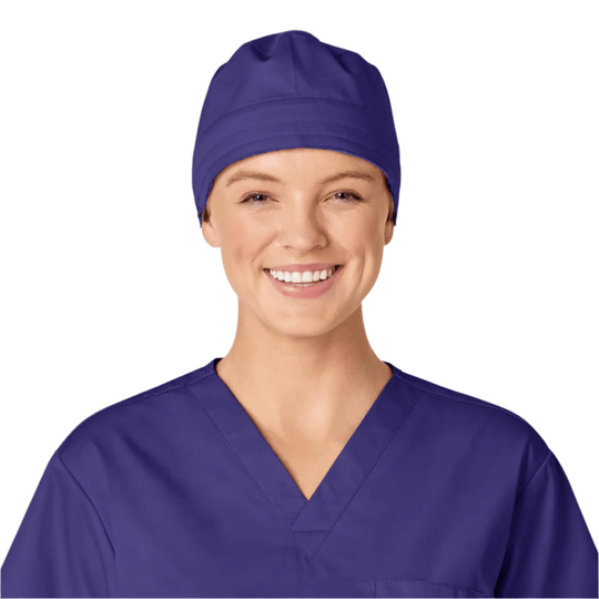 Purple scrub cap worn with matching purple scrubs on a smiling person against a white background
