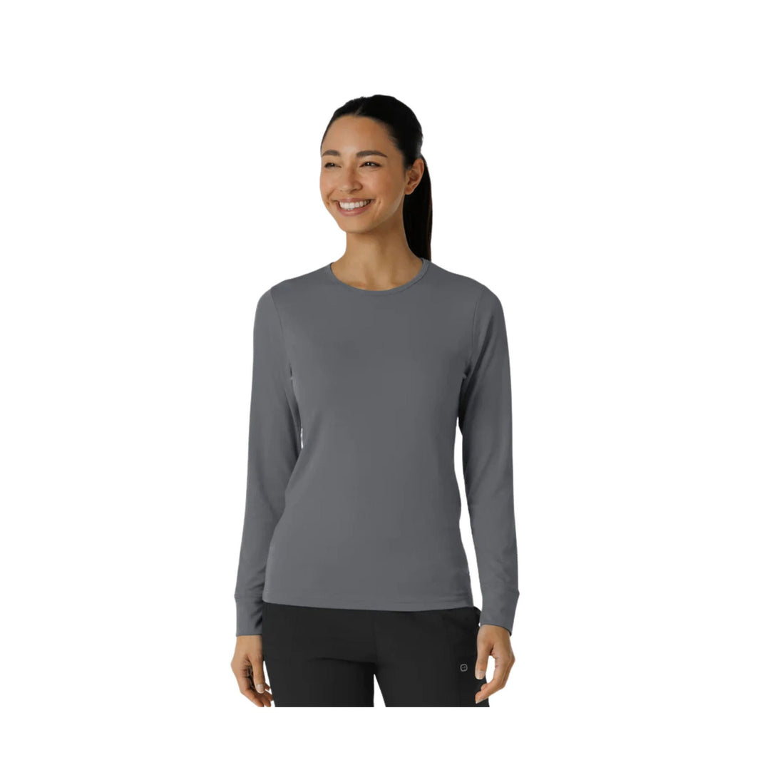 Gray long-sleeve crewneck top on a model, shown with black pants