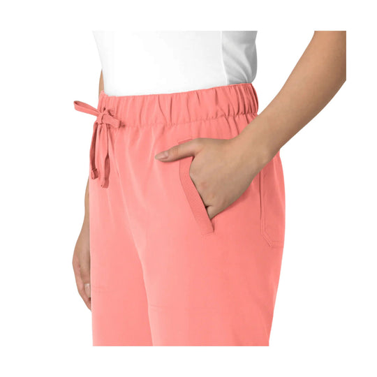Coral-pink scrub pants with an elastic waistband, drawstring tie, and side pockets