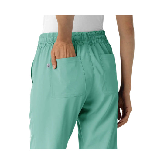 Mint green jogger scrub pants with elastic waistband and back patch pockets, back view