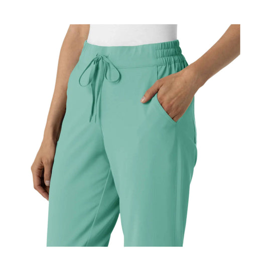 Mint green women’s jogger scrub pants with an elastic waist, drawstring, and side pockets