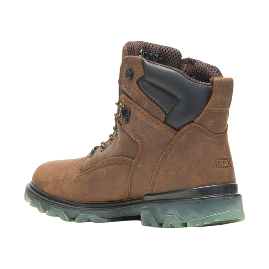 Brown leather work boot with black padded collar, lace-up front, and rugged green outsole