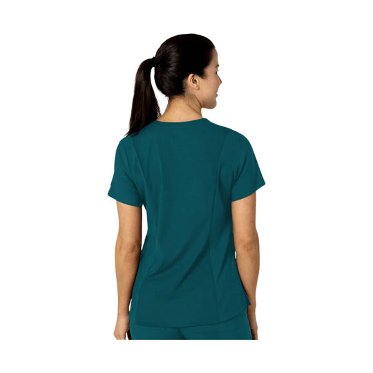 Teal short-sleeve scrub top shown from the back on a model