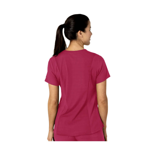 Back view of a magenta short-sleeve scrub top on a model