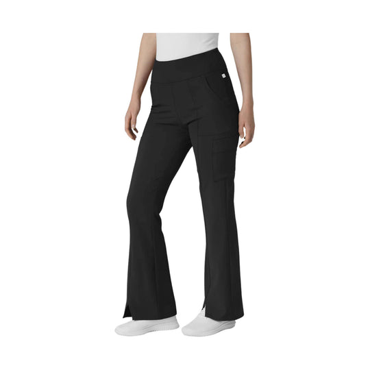 Black high-waisted cargo flare pants with side pockets and slit hems, shown on a model with white sneakers.