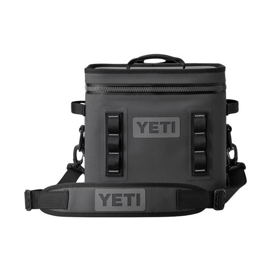 A black YETI insulated cooler bag with a top handle, front zipper, and adjustable shoulder strap, shown on a plain white background.