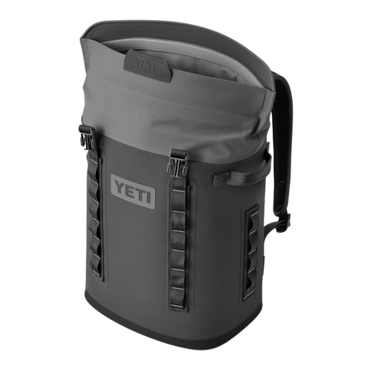 Dark gray roll-top backpack cooler with front straps and a visible YETI logo