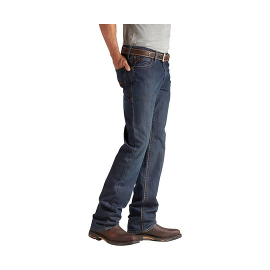 Side view of dark blue boot-cut jeans with brown boots