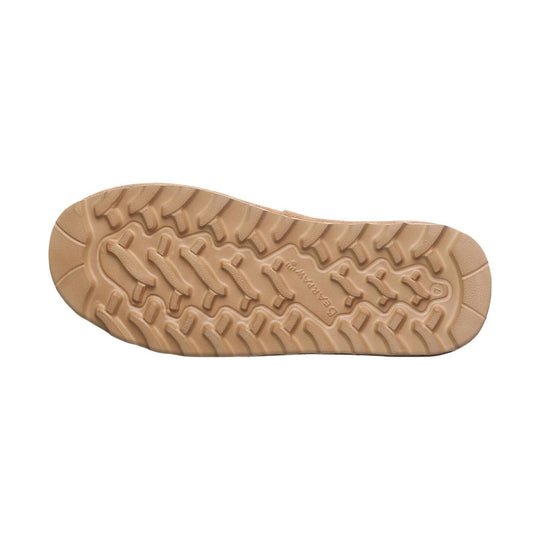 Tan rubber boot outsole with deep lug tread and embossed text at the center