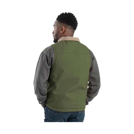 Olive green sherpa-lined vest worn over a gray long-sleeve shirt, shown from the back.