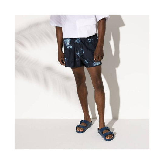 Navy two-strap EVA slide sandals worn with black shorts