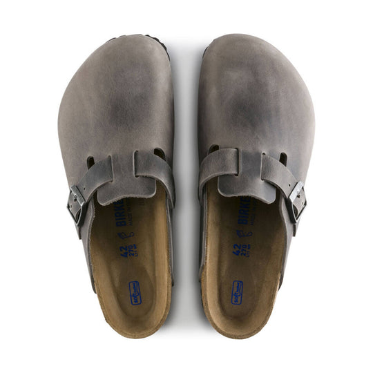 Gray suede clogs with side buckles and contoured cork footbeds, top view