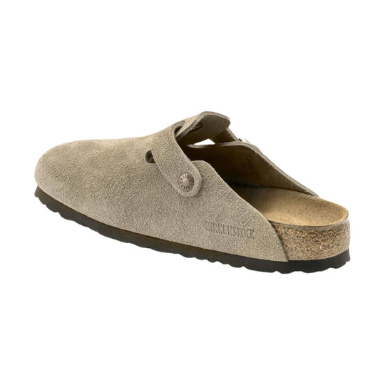 Beige suede clog with an open heel, adjustable strap, and cork footbed