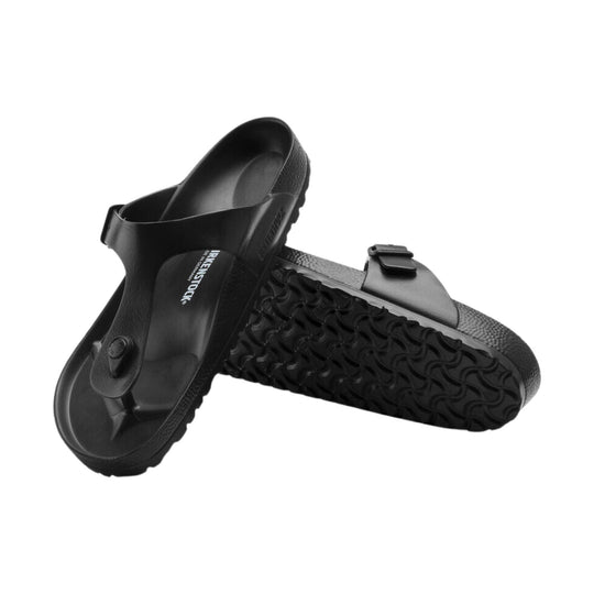 Black molded EVA slide sandals with contoured footbeds and treaded soles
