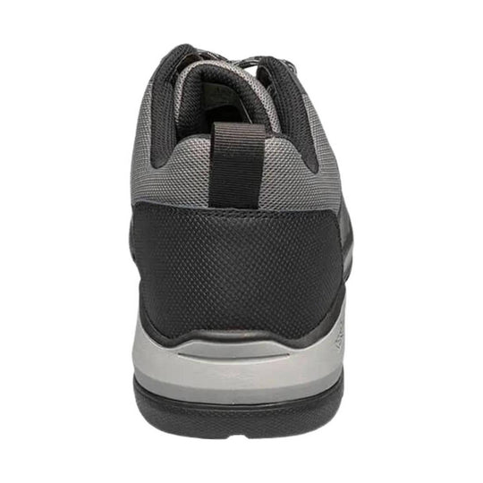 Gray and black low-cut work shoe seen from the back with textured mesh upper and thick sole