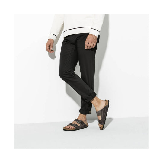 Brown leather double-strap sandals with cork footbeds, shown on a model