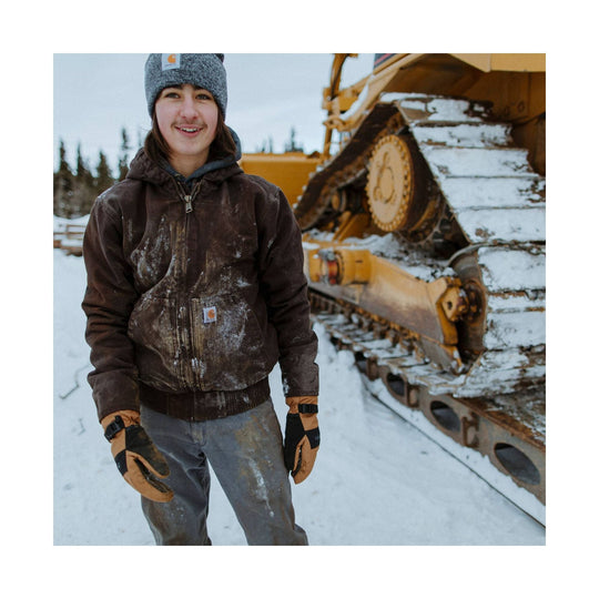 Brown insulated hooded work jacket with Carhartt patch, worn in the snow