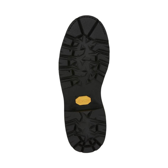Black lugged boot sole with deep tread and a small yellow logo insert