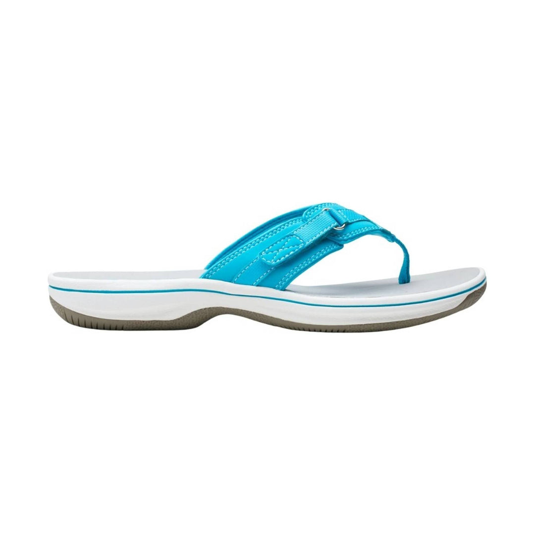 Aqua thong sandal with a thick white sole and cushioned strap, shown in side view