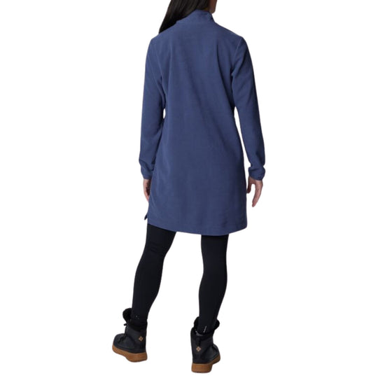 Back view of a blue long-sleeve fleece dress worn over black leggings and black winter boots