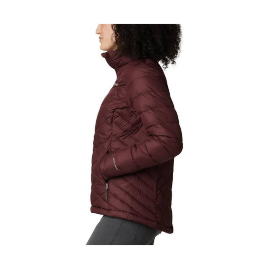 Burgundy quilted puffer jacket in side view with high collar and zip pocket