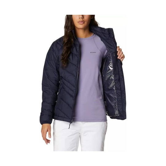 Navy quilted puffer jacket worn open over a lavender top