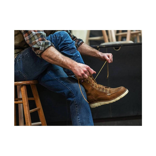 Brown leather lace-up work boot with moc toe, metal eyelets, and white lug sole