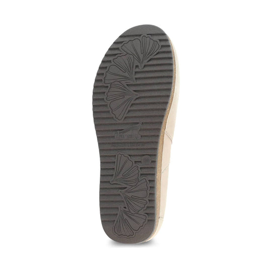 Beige clog outsole with dark ribbed tread and floral leaf pattern