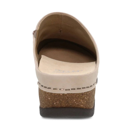 Beige slip-on clog with cork wedge heel, rounded back opening, and dark outsole, rear view