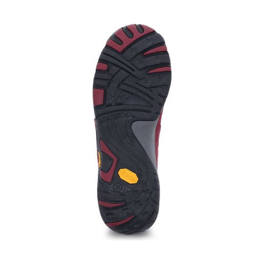Black and burgundy shoe outsole with tread pattern and yellow grip insert