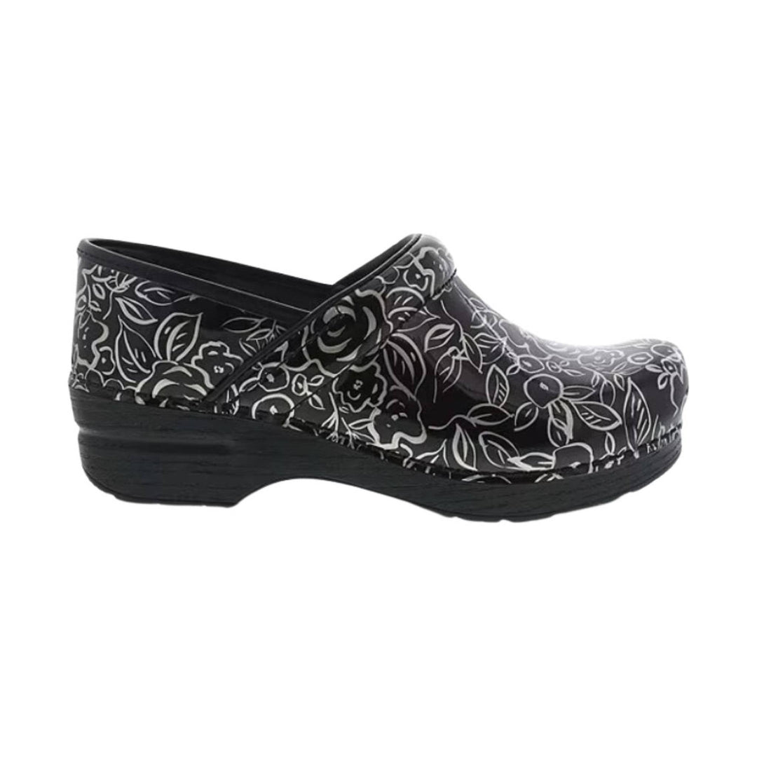 Black clogs with white floral pattern and a chunky wooden-style sole
