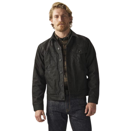 Black button-front jacket over a plaid shirt with dark jeans