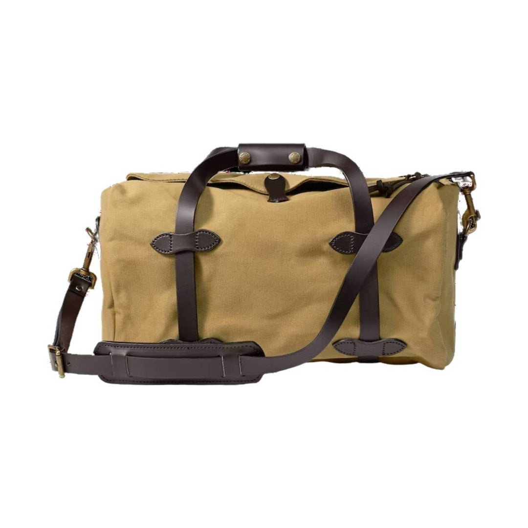 Tan canvas duffel bag with dark brown leather straps and shoulder strap