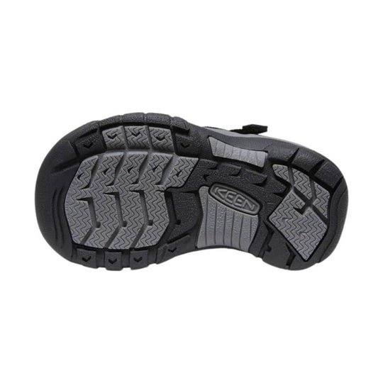 Black kids' sandal outsole with gray tread panels and embossed logo