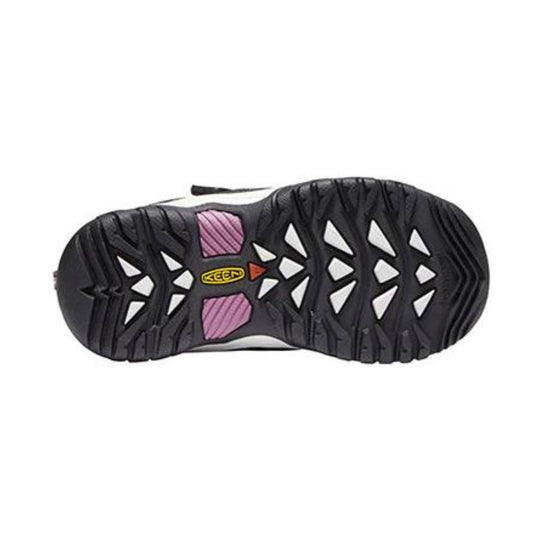 Black hiking shoe outsole with white triangular cutouts and pink tread accents
