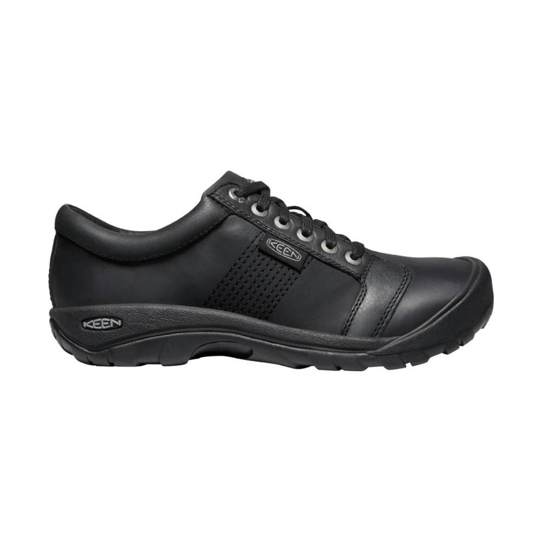 Black low-top walking shoe with lace-up closure and a thick rubber sole